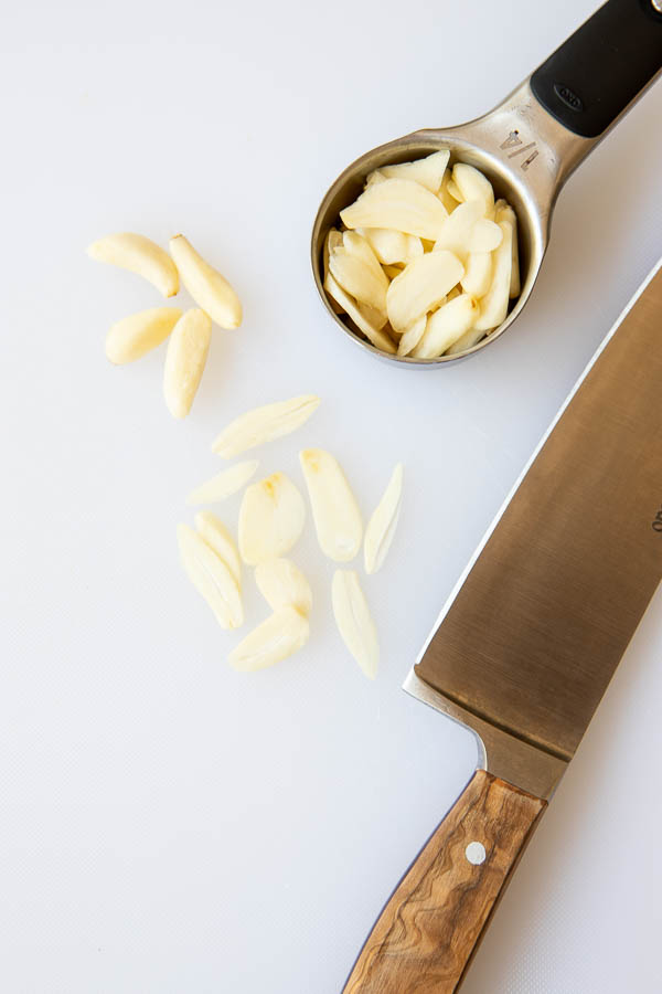 Sliced garlic in a measuring cup for the garlic shrimp 