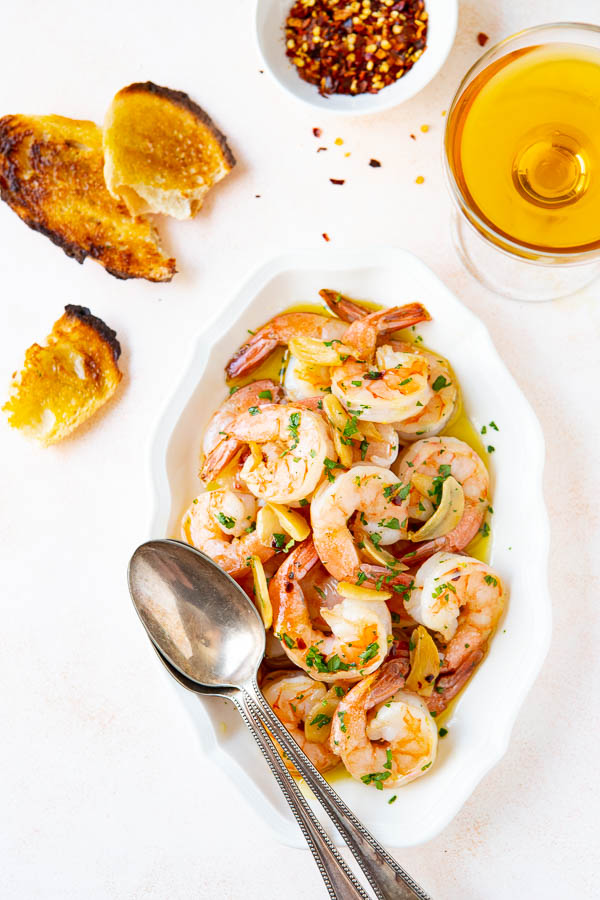 overhead shot of gambas al ajillo on a platter. 