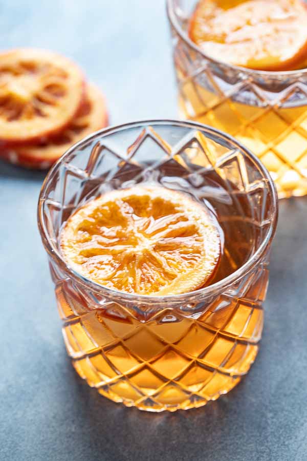 close up of a rocks glass of a this Old Fashioned bourbon drink.
