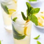 close up shot of the ginger rogers, a gin and ginger ale cocktail with a sprig of mint garnish.