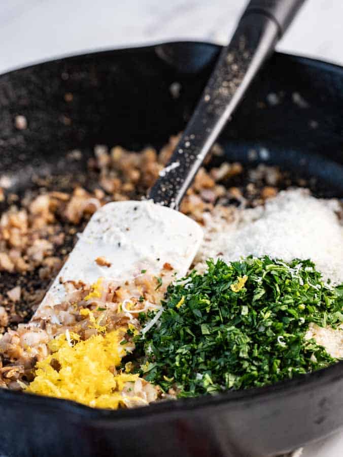 ingredients in a skillet for the stuffed spanish mushrooms