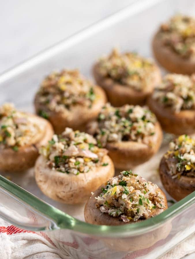 stuffed mushrooms in a casserole dish waiting to be baked.