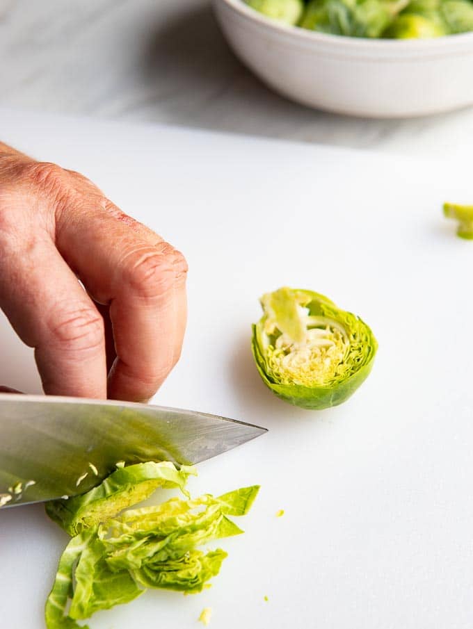 cutting brussels sprouts into thin slices.