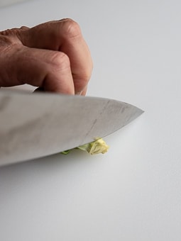 Cutting the stem end off a brussels sprouts