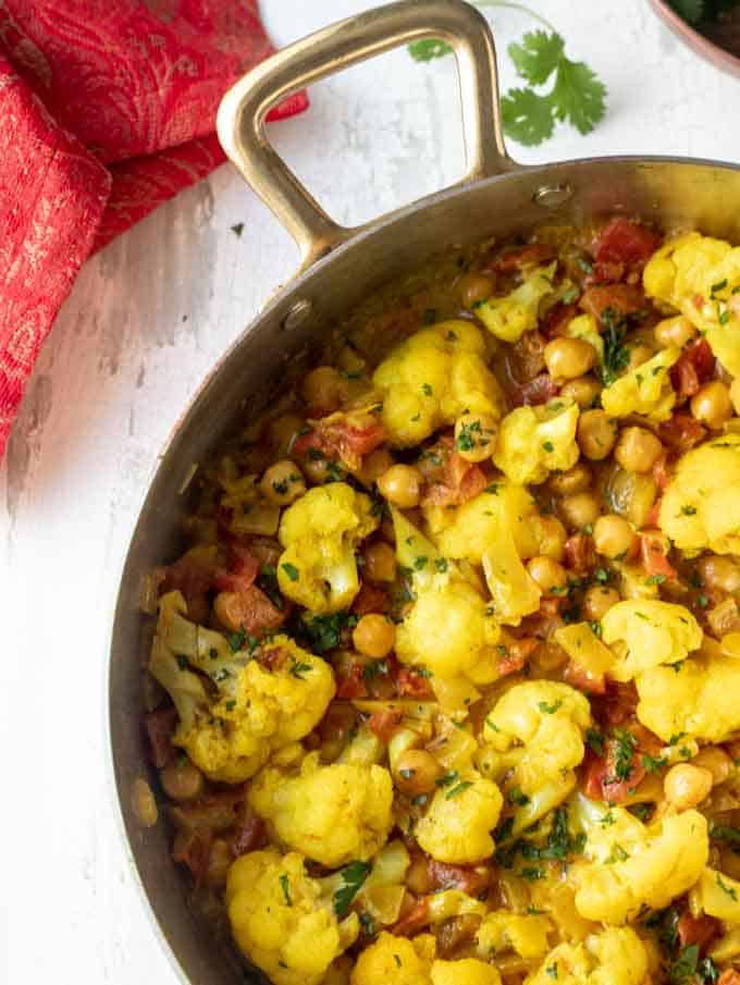 Close up of a skillet with Indian Cauliflower Chickpea Curry. 