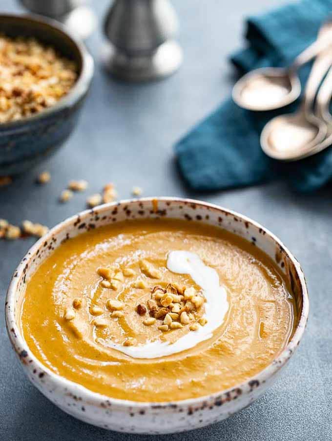 Bowl of african peanut soup with peanut garnish. 