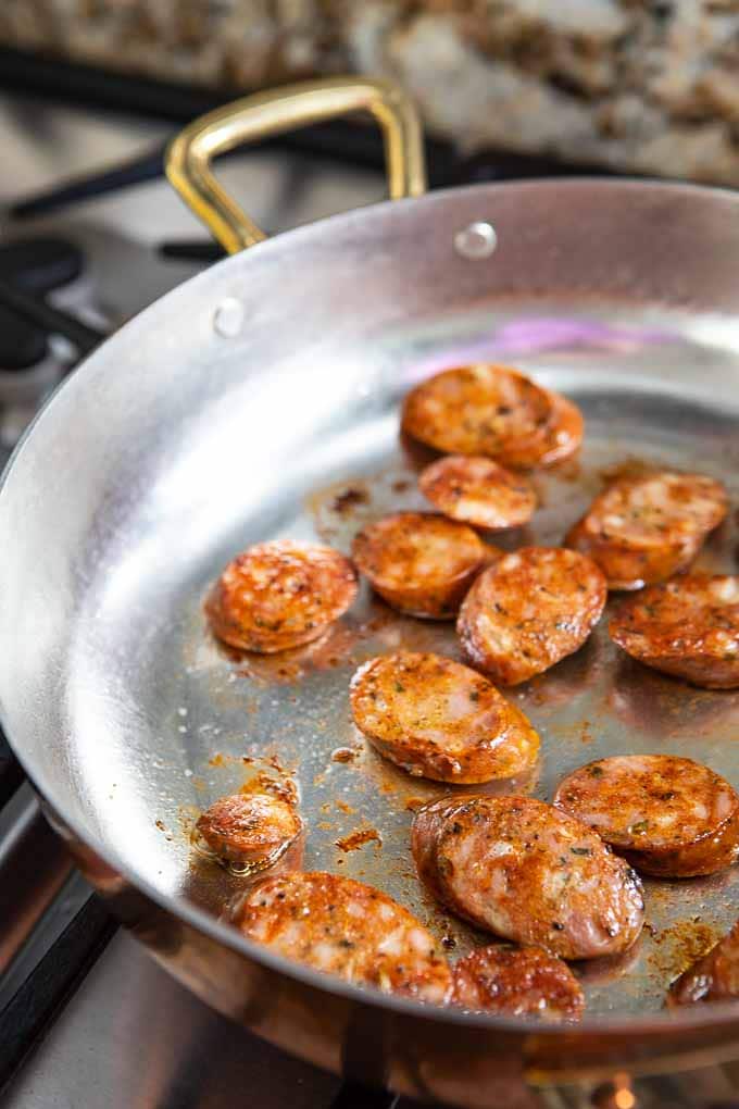 pan with cooked sausage for the italian sausage and peppers