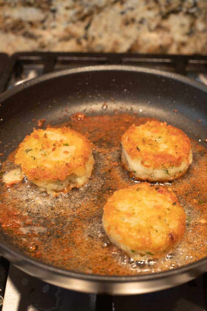 aloo tikki's being cooked in oil.