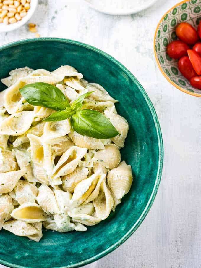 Close up overhead photo of a bowl of creamy basil pasta.
