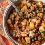 Overhead photo of mexican picadillo recipe with a spoon.