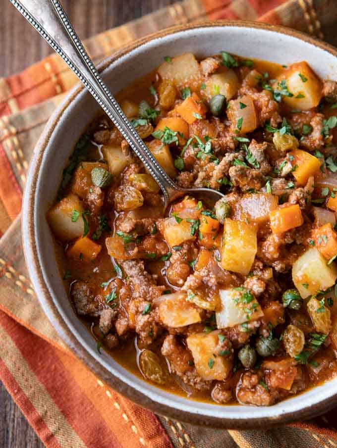 Overhead photo of mexican picadillo recipe with a spoon.