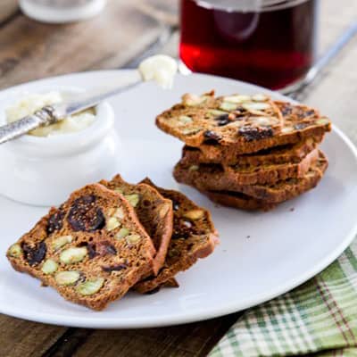 fig and pistachio crackers on a plate with butter