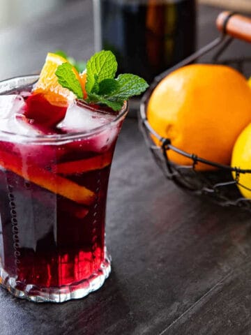 A red wine spritzer cocktail in a glass.