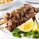 Plate with grilled lamb kebabs.