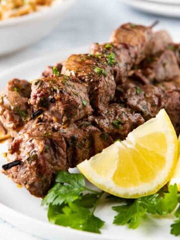 Plate with grilled lamb kebabs.