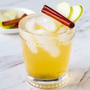 A glass filled with Apple Cider Bourbon Cocktail