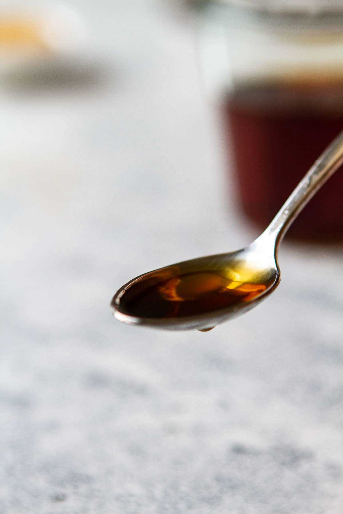 Close up of a a spoon with demerara syrup on it.